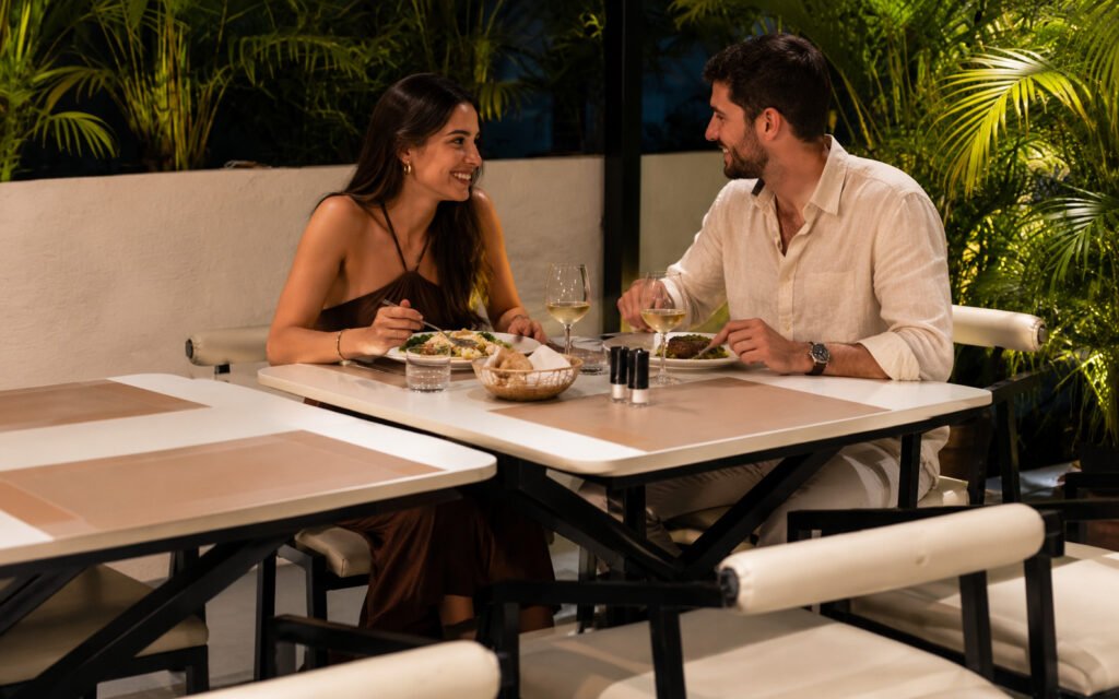 Couple enjoying evening dining at the Best Rooftop Restaurant in Sambhajinagar with green rooftop ambience